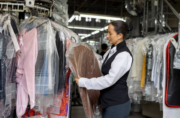istock Employee working at the laundry searching for clothes in a rack 2199286831