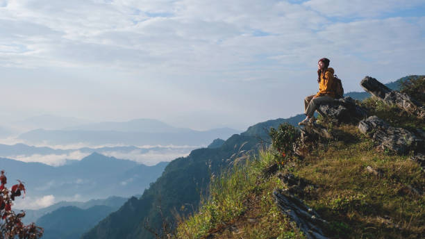 istock A woman sitting on the mountain peak 2199288300