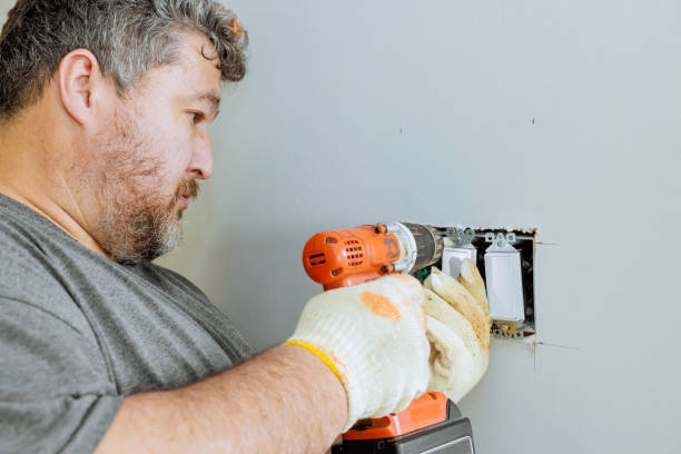 istock Skilled worker installs electrical outlet in residential setting during daylight hours 2199291263