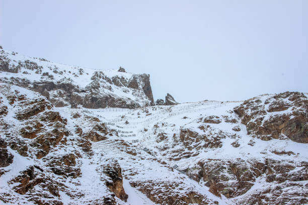 istock Snowy Mountain Landscape with View of Rocky Peaks 2199293402