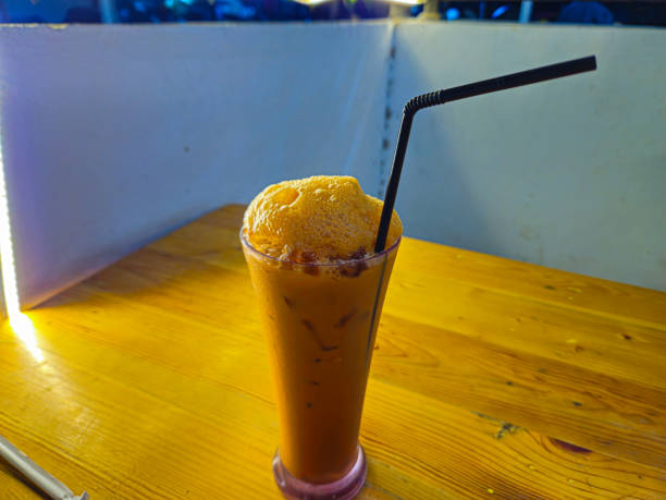 istock Refreshing Thai Iced Tea with Frothy Top and Black Straw 2199293435