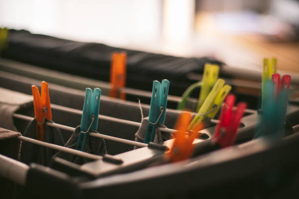A vibrant collection of colorful clothespins perched on a drying rack, showcasing a delightful array of hues that brighten up the laundry experience with creativity.