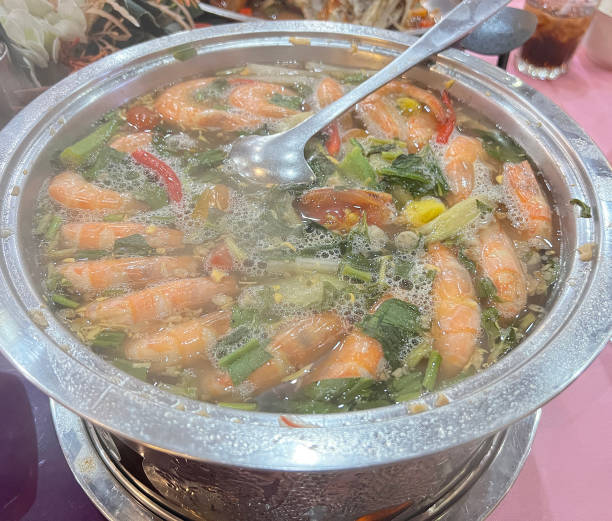 A large hot pot of spicy and sour prawn soup