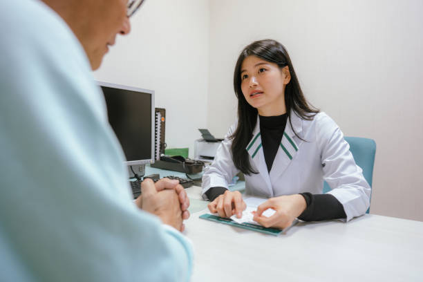 istock Consulting Care: Doctor and Patient Review Check-Up Information 2199300872