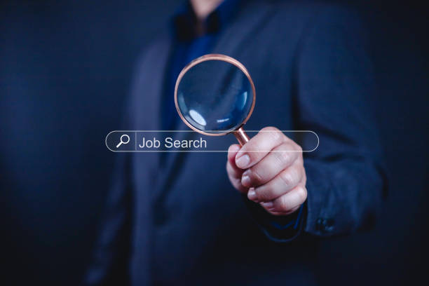 istock Job search concept. Man using magnifying glass for job search and fill out personal data on job website, Internet uesge for optimization in a Job Search. find, opportunity, Job search 2199300969