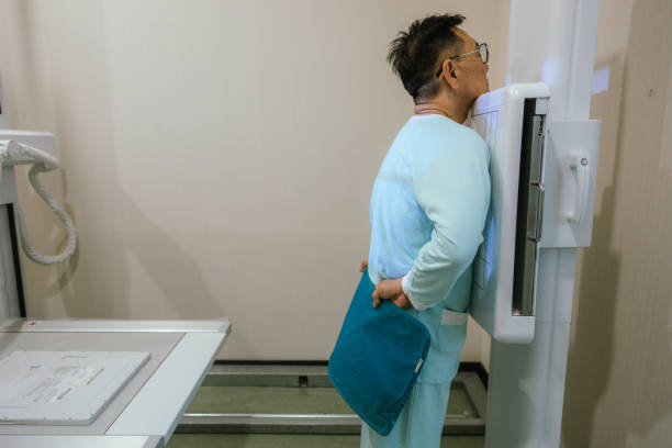 Adult man is undergoing digital chest x-ray examination