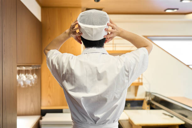 The back view of a worried Japanese chef