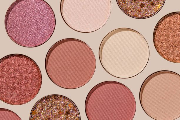 istock Cosmetics texture pattern, Warm vivid colored eye shadow makeup palette, round eye powder swatches. Female cosmetic and beauty products, aesthetic minimal beauty photo, colorful eyeshade, top view 2199302263