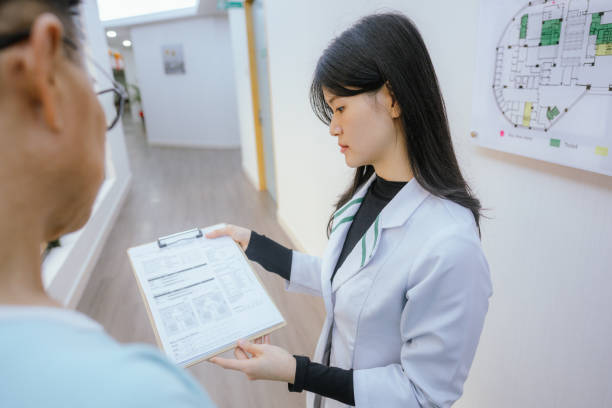 istock Informed Care: Doctor and Patient Discuss Health Data 2199302485