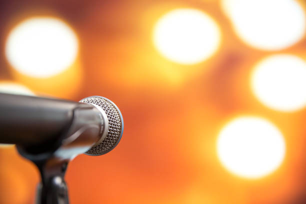 istock Public speaking backgrounds, Close-up the microphone on stand for speaker speech presentation  stage performance with technology blur bokeh light background. 2199302846