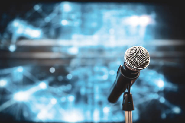istock Public speaking backgrounds, Close-up the microphone on stand for speaker speech at seminar room with technology light background and blur bokeh. 2199303184