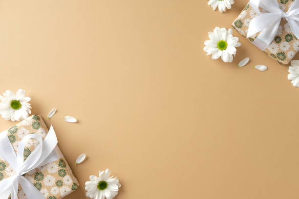 istock Happy Mothers Day flat lay composition with gift boxes and chamomile flowers on pastel beige background. 2199303393