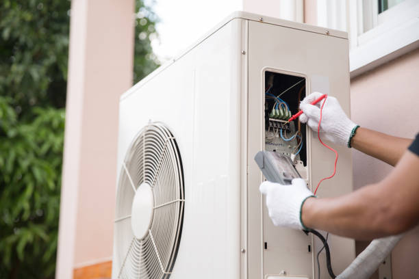 istock Close up hand of technician using measuring equipment to checking electric current voltage at circuit breaker on outdoor air compressor unit after installation and air conditioner services maintenance 2199303418