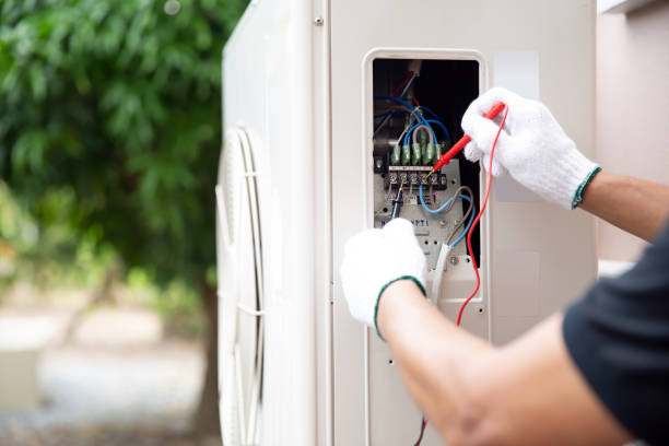 istock Close up hand of technician using measuring equipment to checking electric current voltage at circuit breaker on outdoor air compressor unit after installation and air conditioner services maintenance 2199303421