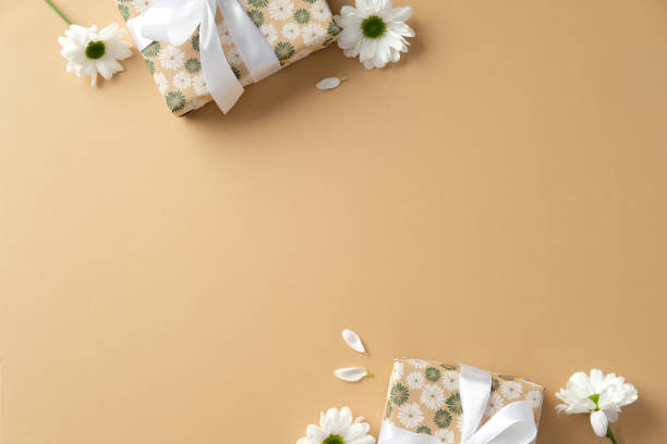 istock Happy Mothers Day flat lay composition with gift boxes and chamomile flowers on pastel beige background. 2199303459