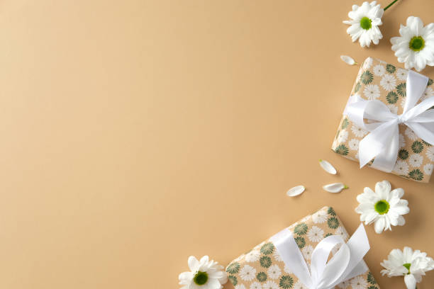 istock Happy Mothers Day flat lay composition with gift boxes and spring flowers on pastel beige background. 2199303464
