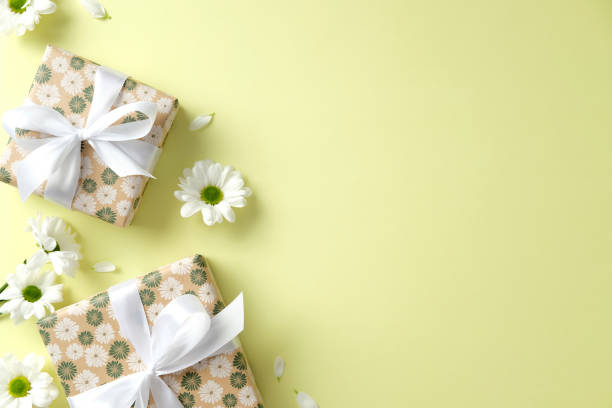 istock Happy Mother's Day concept. Flat lay composition with gift boxes and chamomile flowers on green background. 2199303500