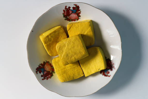 tahu kuning or yellow tofu on white plate isolated on white background