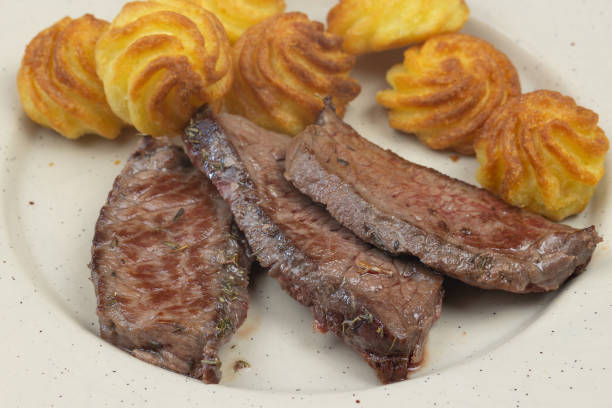 cooked roast beef and noisette potatoes, close-up
