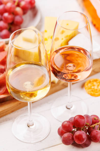 istock A delectable arrangement of various cheeses, fresh grapes, prosciutto and wine 2199307616