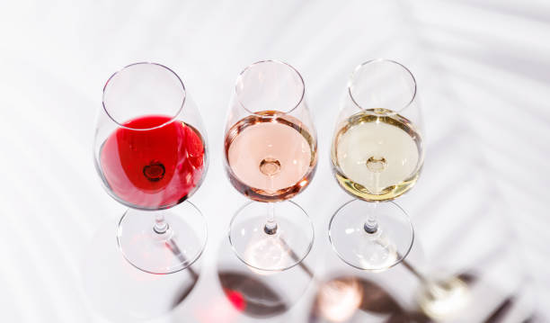istock Three wine glasses filled with red, white, and rose wine 2199307648