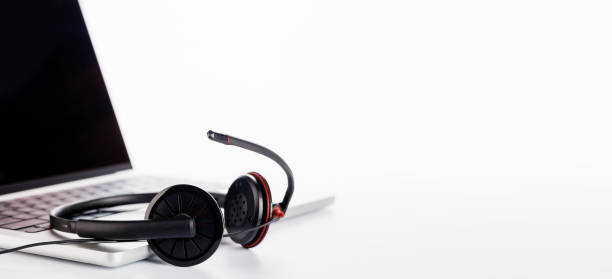 istock A sleek headset resting on a laptop, set against a bright white background 2199307730