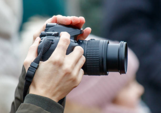 istock A person is holding a camera and taking a picture 2199307918