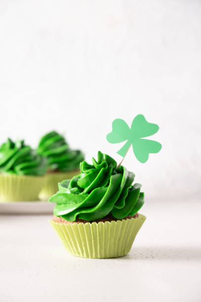 istock St. Patrick's Day tasty cupcake with green whipped cream. 2199313224