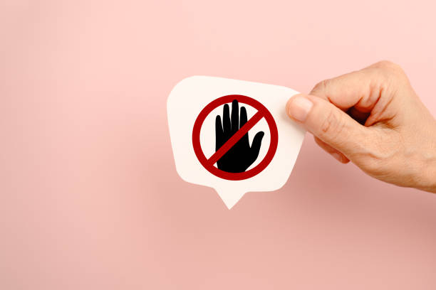 istock hand hold symbol for prohibition, do not touch on real white speech bubble paper cut on pink background 2199314198