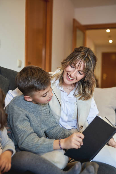 istock Mother and son reading a book together and sharing a joyful moment 2199318064