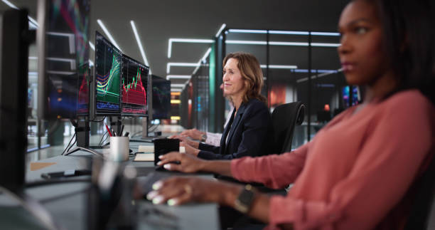 istock Busy stock broker team in office analyzing charts and data. 2199318816
