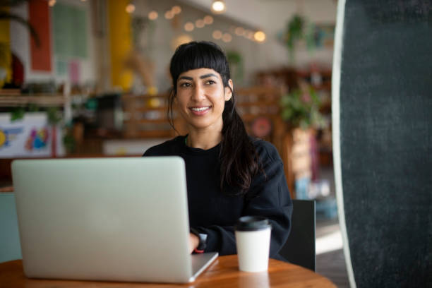 istock Laptop, remote work and thinking with woman in coffee shop for small business planning or research. Computer, idea and vision with happy freelance employee in cafe or restaurant for design startup 2199320607
