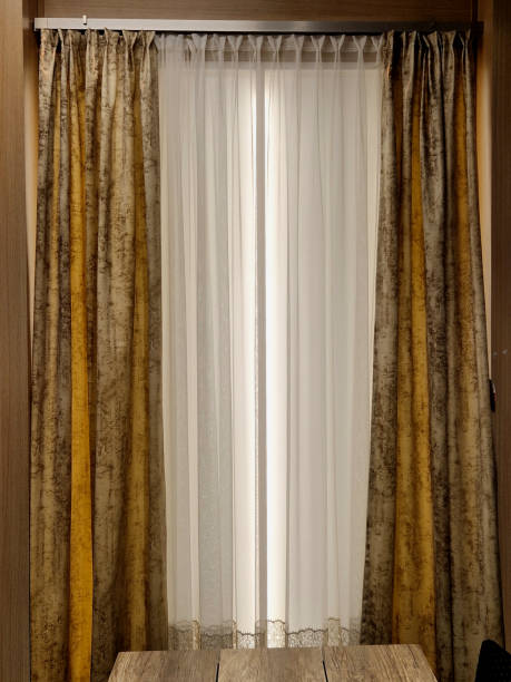 istock a curtain on a stainless steel console with a light-impermeable fabric and a soft curtain with white color. dark blue brocade with a geometric pattern and yellow mottled 2199321629