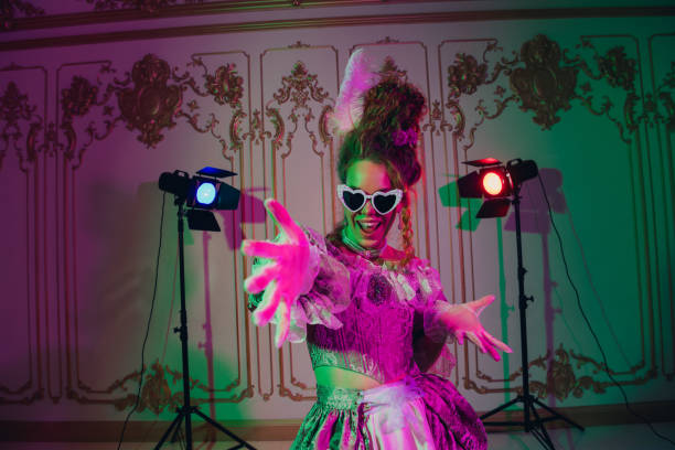 istock Elegant Woman in a Baroque Costume Under Dramatic Spotlight Lighting in a Regal Interior Setting 2199321932