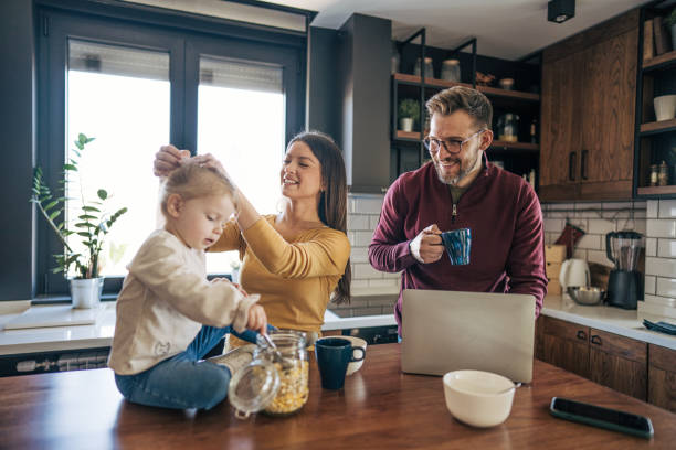 istock Family enjoying morning routine in modern kitchen 2199321940
