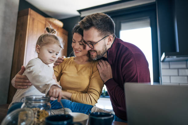 istock Happy family having breakfast in the kitchen 2199322016