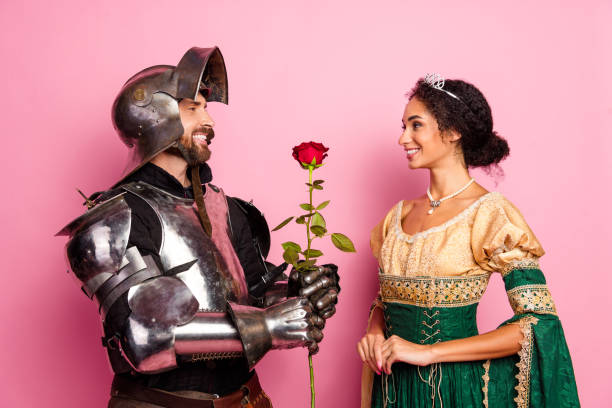 istock A medieval couple in costume with a romantic gesture on a pink background 2199322610