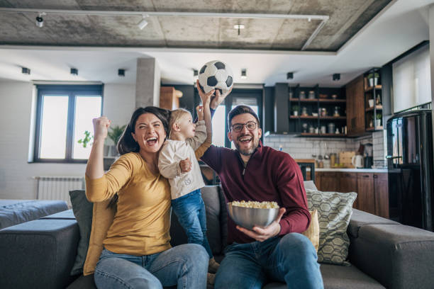 istock Family celebrating soccer game with joyful expressions 2199322665
