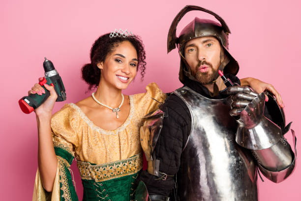 A knight and woman dressed in medieval attire pose humorously with modern items, symbolizing the intersection of historic elegance and contemporary quirks.