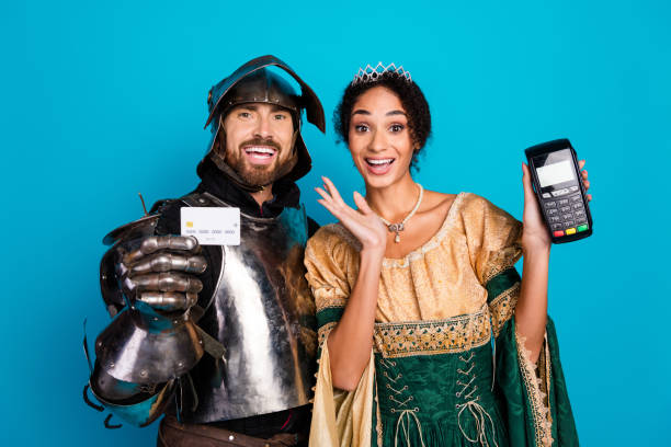 istock Playful couple in vintage costumes posing with modern payment methods 2199322763