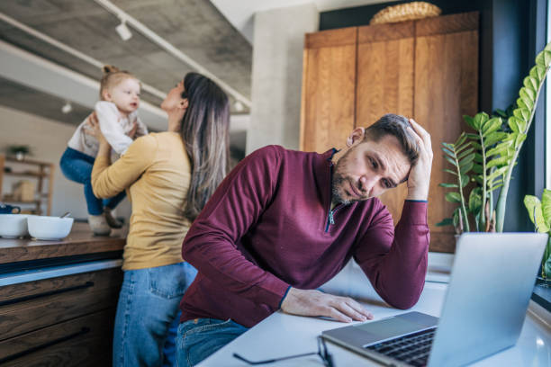 istock Stressed father working from home with wife and daughter 2199323166