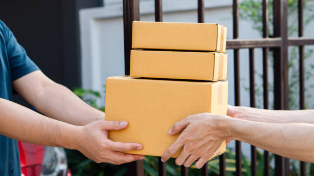 istock Service and delivery concept. Delivery man holding an empty parcel box The courier delivers the item urgently. Online store, postman, delivery service, parcel delivery with good depth of field 2199324374