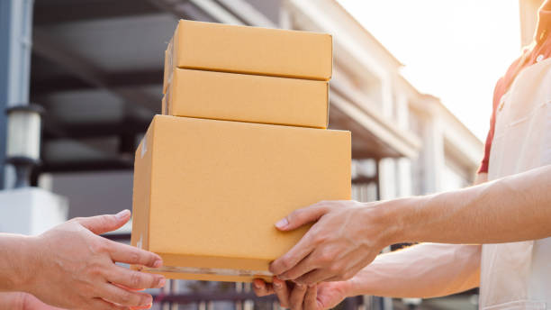 istock Service and delivery concept. Delivery man holding an empty parcel box The courier delivers the item urgently. Online store, postman, delivery service, parcel delivery with good depth of field 2199324376