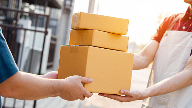 istock Service and delivery concept. Delivery man holding an empty parcel box The courier delivers the item urgently. Online store, postman, delivery service, parcel delivery with good depth of field 2199324461