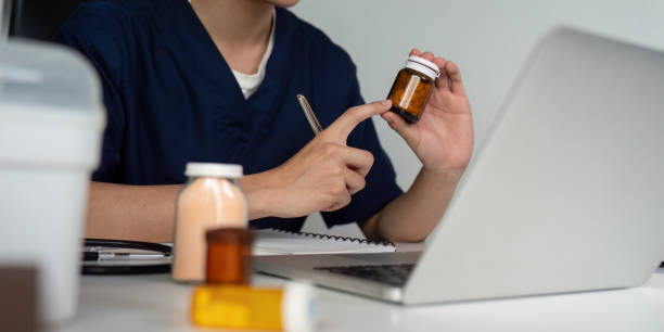istock Medical student analyzing medication while engaged in an online study session with a laptop. 2199325930