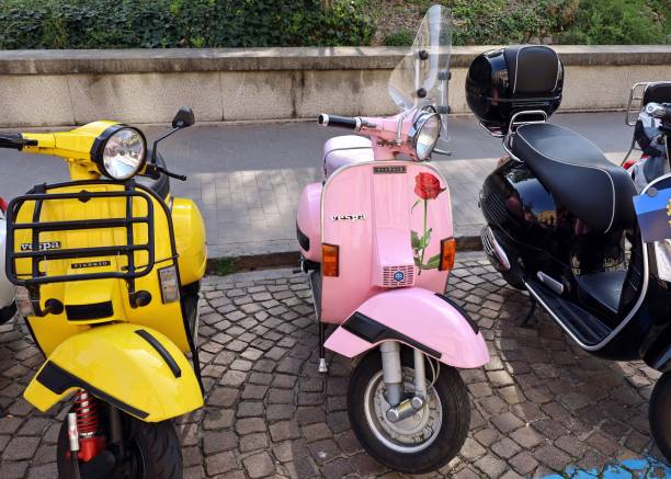 Pink moped / swallow in front of a house facade
