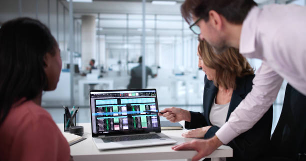 istock Busy Business Professionals Collaborating on Spreadsheet Report 2199327798