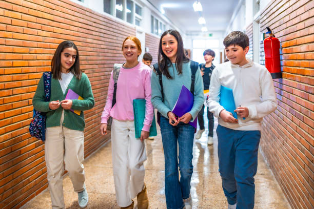 istock Group of students walking in school hallway 2199328170