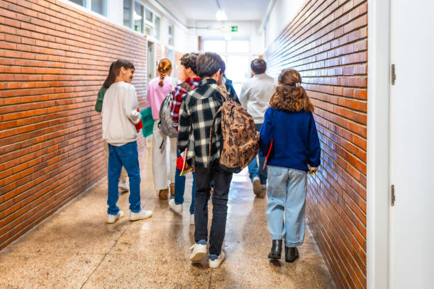 istock Group of students walking in school hallway 2199328180