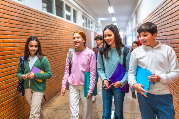 istock Group of students walking in school hallway 2199328185
